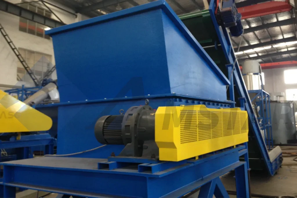 Debaler with blue hopper, gear motor and yellow drive guard