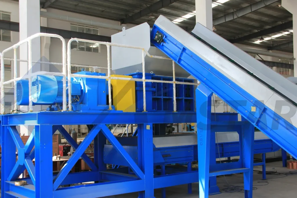 Double-shaft shredder on a blue steel frame with belt conveyor