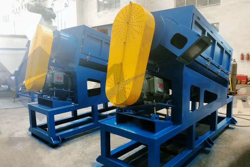 Two high speed friction washers with yellow belt guards and drive motors