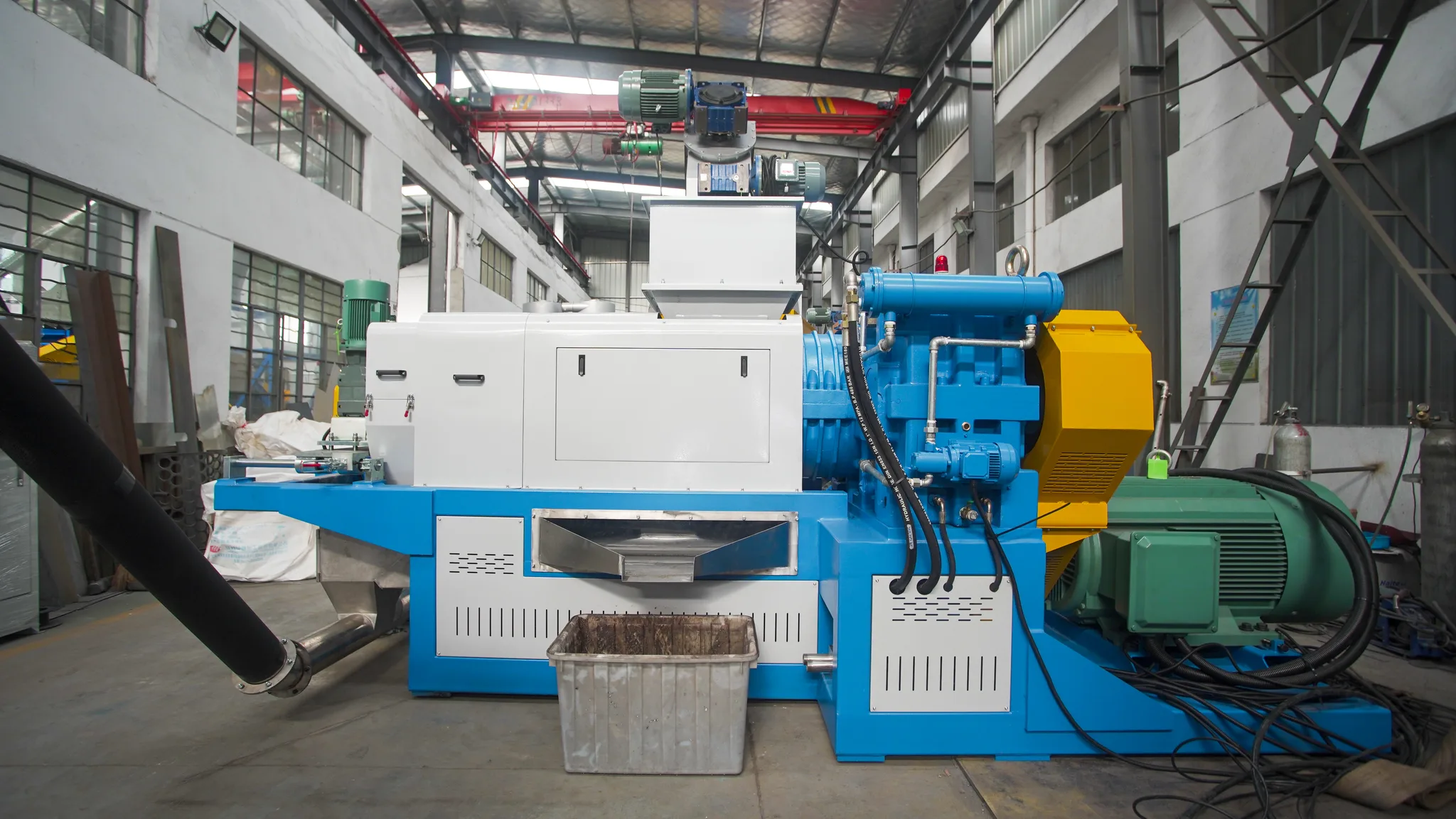 Screw press squeezer that dewaters and densifies washed PE film