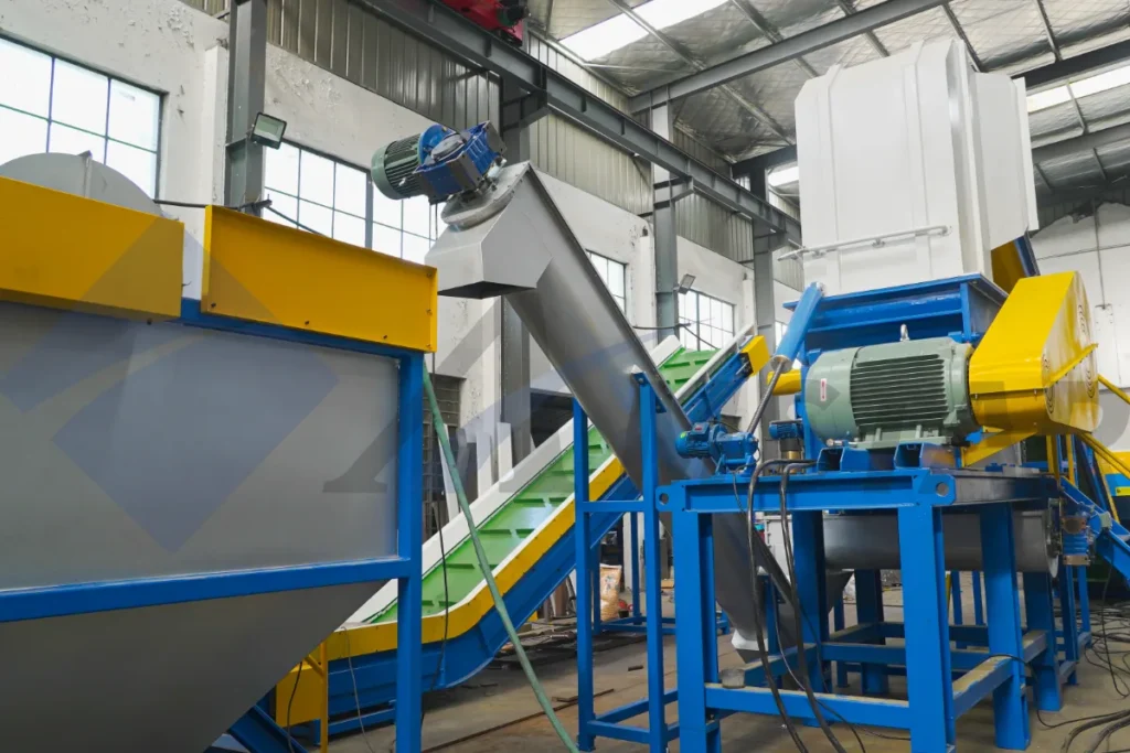 Plastic granulator with motor, screw loader and belt conveyor