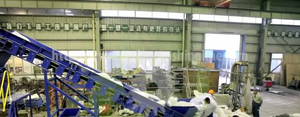 PP / PE film washing line in Mexico – inclined belt conveyor feeding film into the line