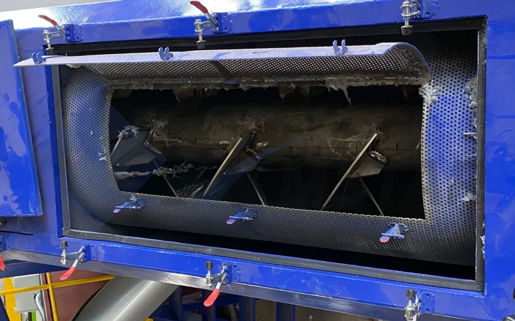 Friction screw washer with its access door open, showing the paddle rotor and screen