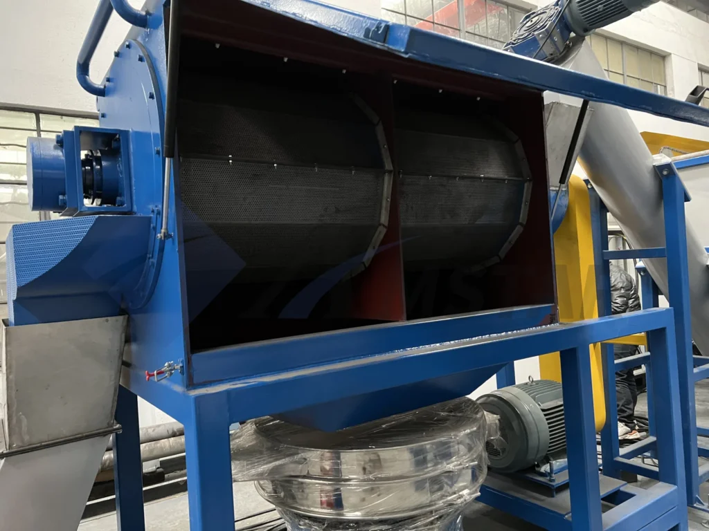 High speed friction washer with the top cover open, showing the mesh screen chamber